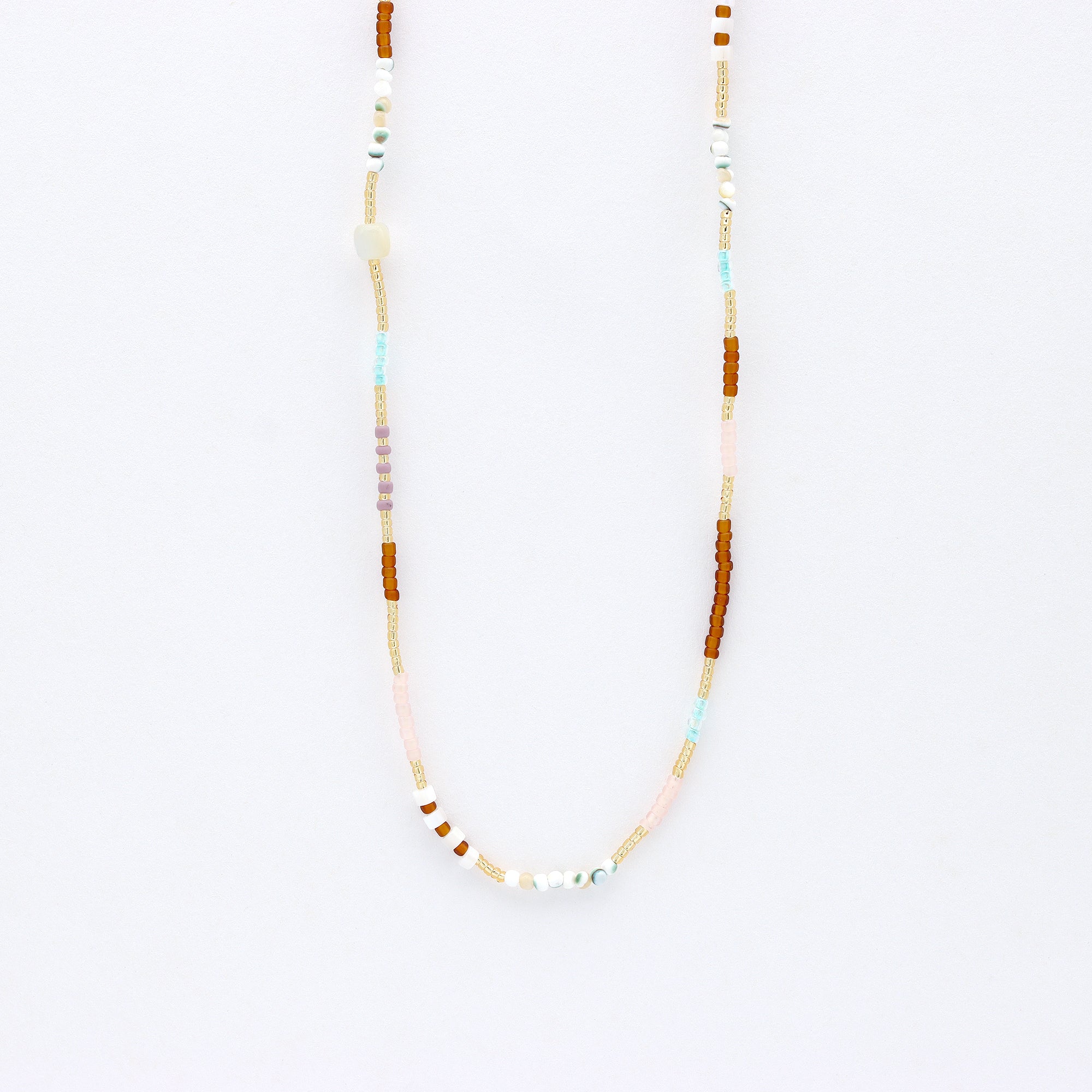 Dainty beaded necklace, in gold, brown and natural tones.