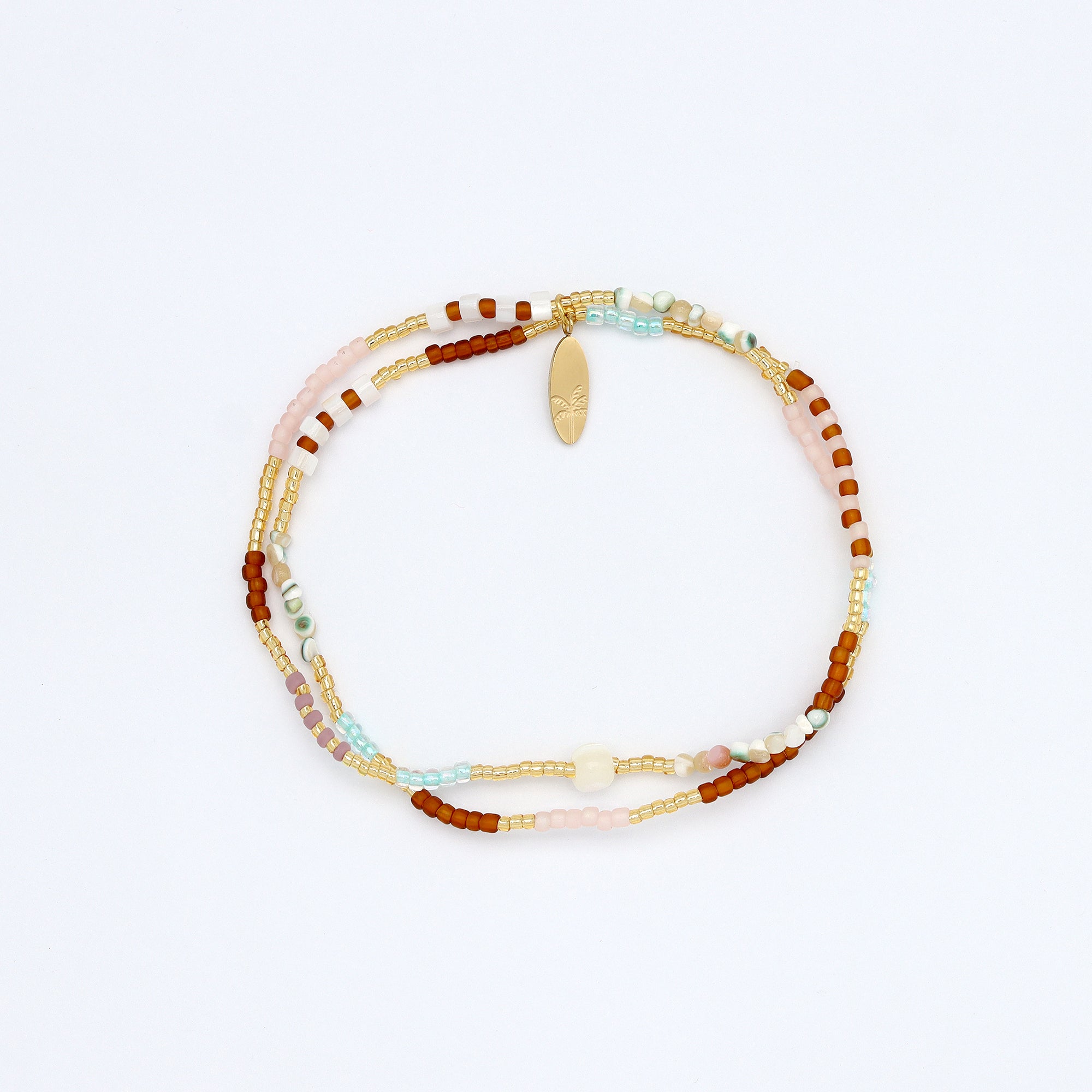 Doubled over style elasticated bracelet, in gold, brown and natural tones.