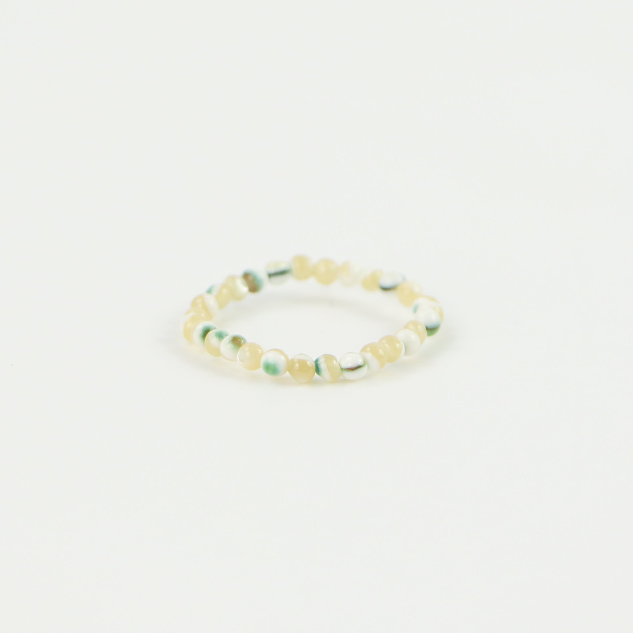 Natural and green tone beaded stretchy ring