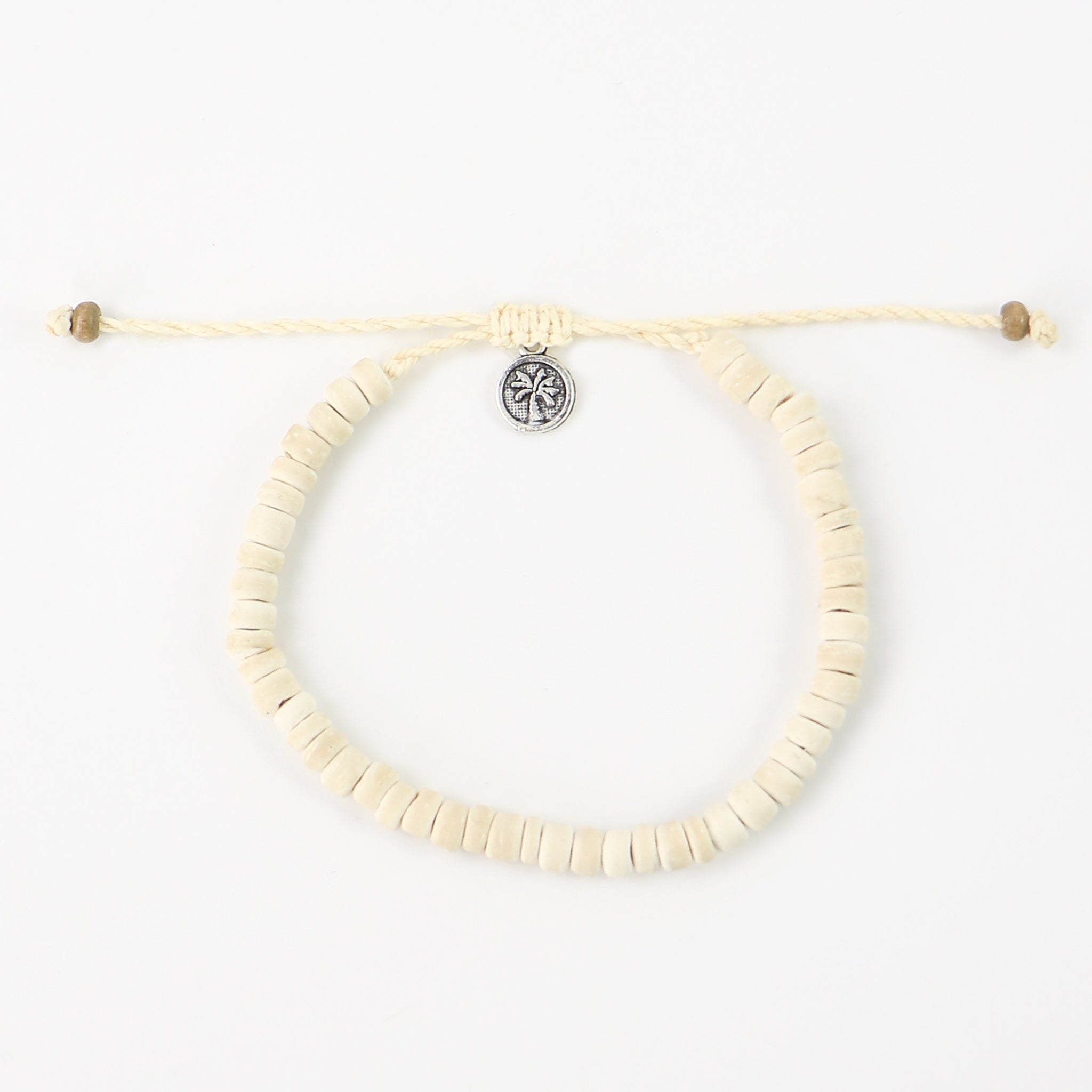 Light coloured coconut wood beaded bracelet. Coconut wood beads are threaded on a natural cream colour wax polyester, finished with our signature textured palm tree tag.
