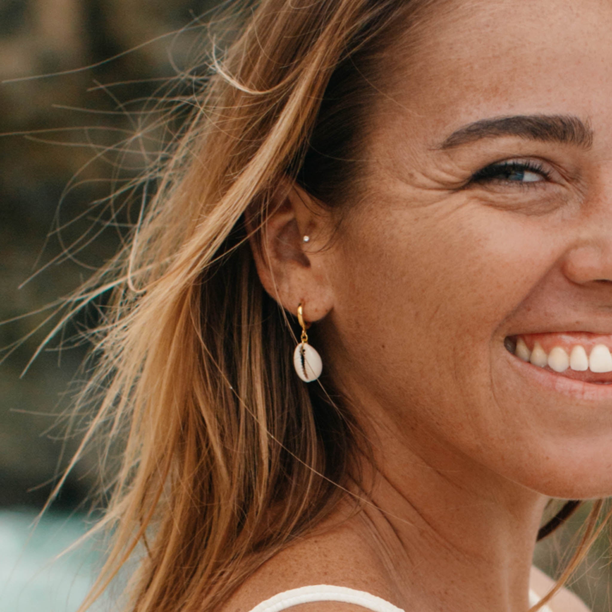 Asri Cowrie Shell Earrings with a gold copper alloy huggie hoop - Pineapple Island