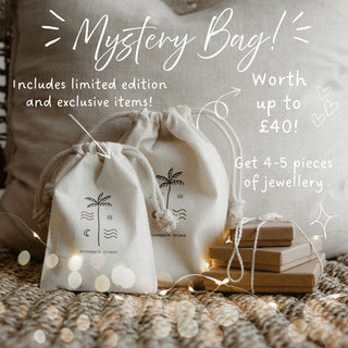 Mystery bag with jewellery packaging and text 'Mystery Bag, Includes limited edition and exclusive items!, worth up to £40, get 4 to 5 pieces of jewellery!'