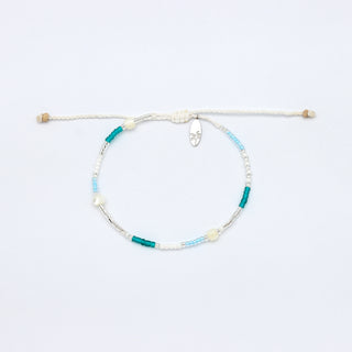 Beaded bracelet with blue, silver, and white beads on a white background