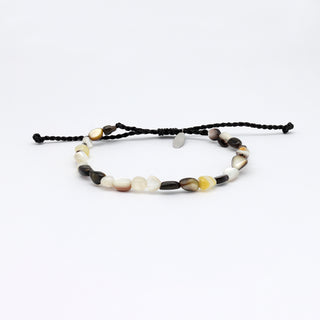 A dark mother of pearl beaded bracelet on a white background