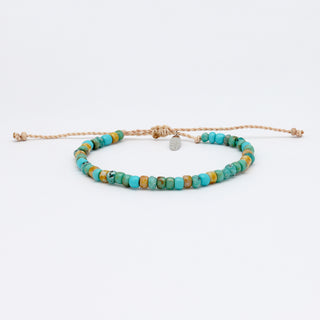 beaded bracelet with turquoise and yellow beads on a white background