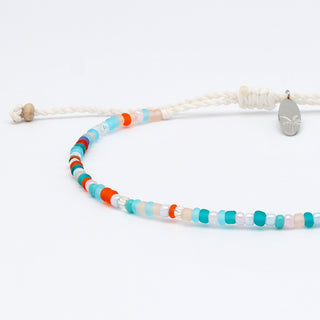 Close up of a colourful beaded bracelet on a white background