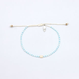 Beaded white and light blue colour bracelet with a pearl in the centre, on a white background