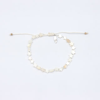 Beaded bracelet with star shaped mother of pearl and silver glass seed beads on a white background