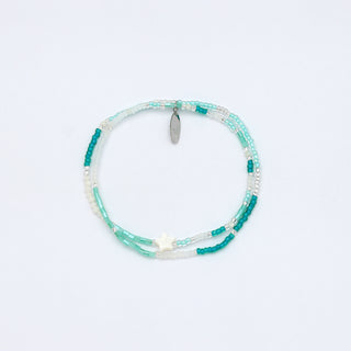 Beaded necklace with turquoise and white beads, and a star accent on a white background