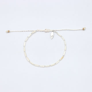 Mother of pearl and silver beaded bracelet on a white background