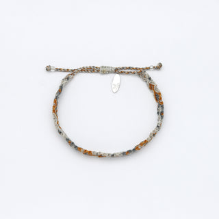 Handwoven bracelet in off-white, gray and golden orange on a white background