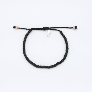 Black painted wood beaded bracelet on a white background