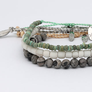 Stack of beaded bracelets on a white background