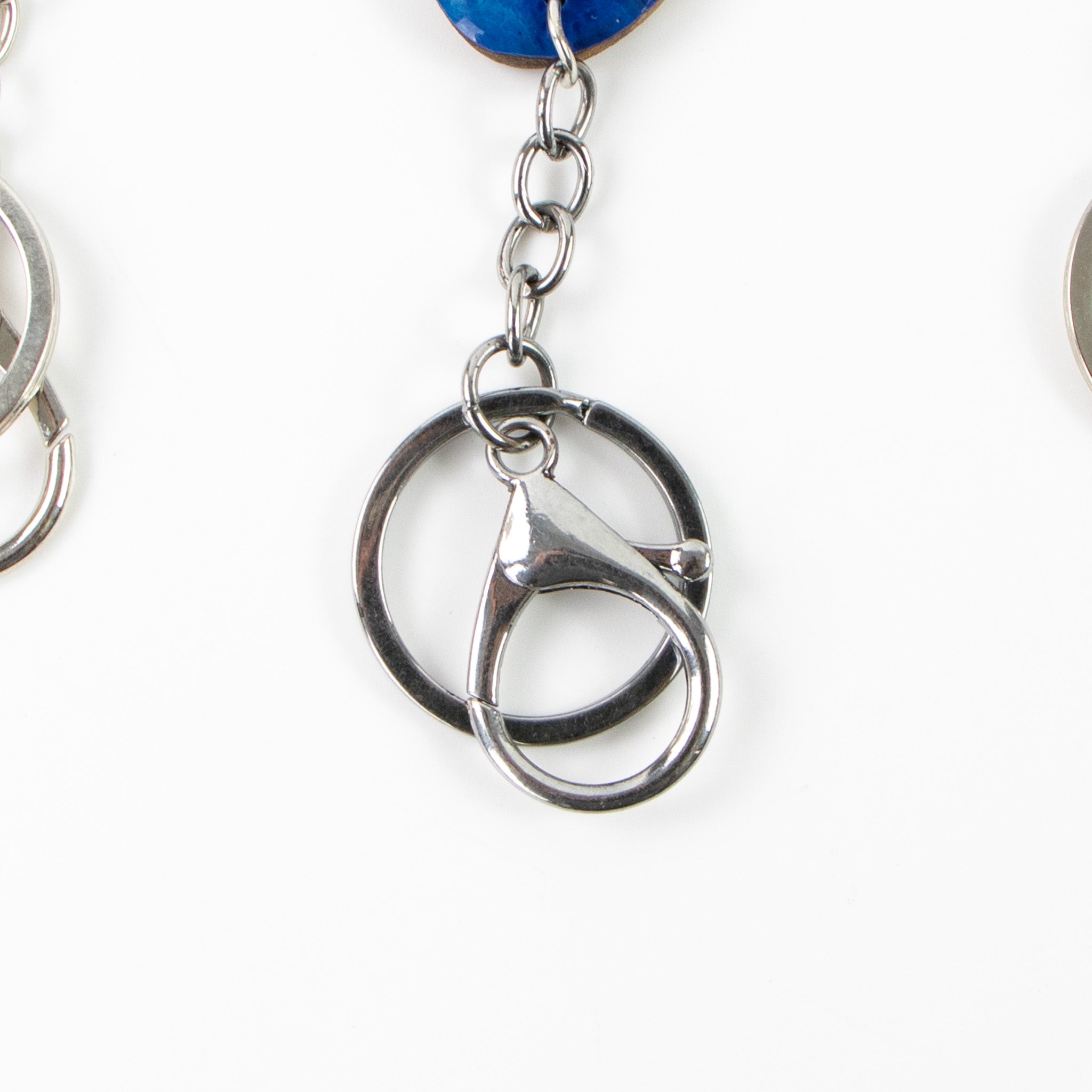 Close-up of a silver keychain with interlocking rings on a white background
